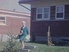 Une dame sort du bungalow avec sa valise - Départ