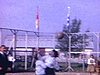 Fête de paroisse dans un village; gang de gars qui s'amusent; partie de ballon-chasseur entre filles 