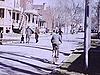 Bicyclettes dans les rues de Ste-Anne-de-Bellevue (ou Longueuil?); plans sur les maisons
