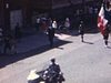 Parade Fête-Dieu vue du balcon dans Rosemont Montréal. (scouts, fanfares, militaires, gymnastes, Dominique Savio, fillettes en robes longues, garçons en moine, statue de Saint Joseph