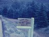 Cap Breton - enseigne «Camping Grand-Anse» camping site assez vide - paysages montagneux