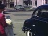 Mariée monte dans l'auto. Les invités arrivent à l'église et discutent sur le trottoir