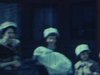 Deux femmes et 2 petites filles sortent de l’église ou de l’hôpital (?) avec un bébé emmitouflé dans une couverte, puis elles montent dans une automobile - Ahuntisic 1963