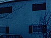 En hiver, extérieur d’une maison, petit garçon marche seul dans la neige, puis tient la main d’une femme, deux hommes discutent dehors
