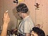 Des femmes fument et discutent  en regardant les cadeaux de première communion d’une fillette