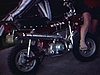 Une motocyclette Honda, deux enfants posent au garage près de la moto, un garçon est monté dessus et s’amuse  